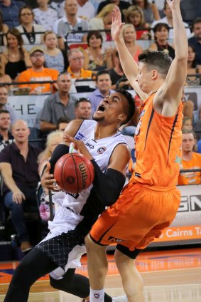 Melbourne United guard Stephen Holt attempts to drive against Cairns Taipans.