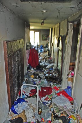 The hallway of a Melbourne apartment belonging to a person with a hoarding problem following a fire.