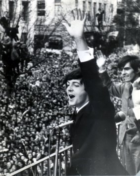 Paul McCartney waves to fans in Melbourne outside the old Southern Cross Hotel on the corner of Bourke and Exhibition streets in June 1964.