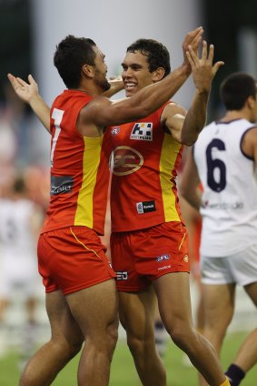 Harley Bennell with former Suns player Karmichael Hunt in 2012.