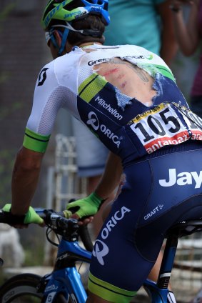 Michael Matthews of Australia riding for Orica-GreenEdge exhibits a torn jersey as he attempts to rejoin the peloton after being involved in a crashin the Tour de France this year.