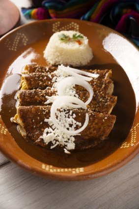 In Mexico, keep your eyes peeled for "enmoladas" -  a dish of corn tortillas drowned in mole sauce. 
