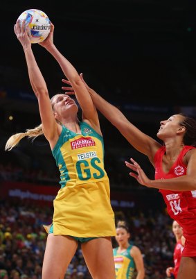 Caitlin Bassett of Australia stretches to take the ball ahead of England's Geva Mentor.