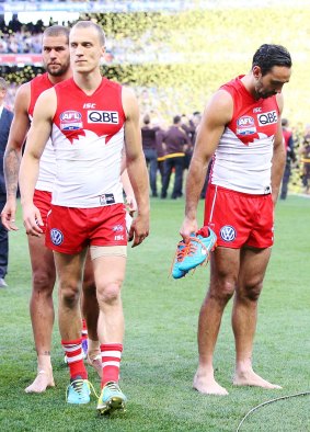 Disappointing finale: Lance Franklin, Ted Richards and Adam Goodes walk off dejected after the grand final in 2014.