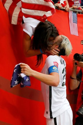Abby Wambach celebrating Team USA's World Cup win with wife Sarah Huffman in 2015.