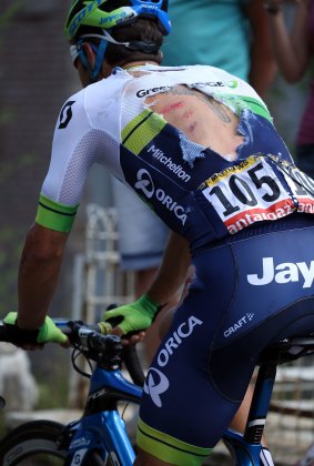 Michael Matthews of Australia riding for Orica-GreenEdge exhibits a torn jersey as he attempts to rejoin the peloton after being involved in a crash with 65km remaining in stage three of the 2015 Tour de France from Anvers to Huy on July 6, 2015 in Huy, Belgium.