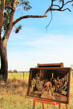  A print of Tom Robert's famous painting on an easel at the location where the woolshed featured in the painting stood prior to being destroyed by fire.
