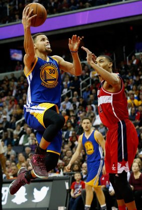 Taking it to the hoop: Stephen Curry puts up a shot in front of Otto Porter.