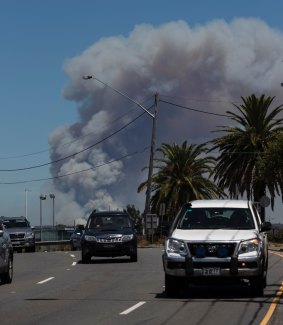 The view across Sutherland Shire from Captain Cook Bridge towards a fire in the Royal National Park.