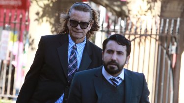 Charles Waterstreet (left) arrives at the murder trial of Roger Rogerson and Glen McNamara in July.