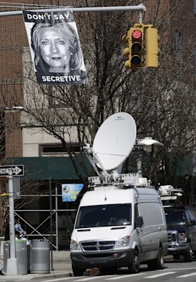 An unknown artist placed a poster on a traffic signal in front of the building where Hillary Rodham Clinton's presidential campaign offices are located.