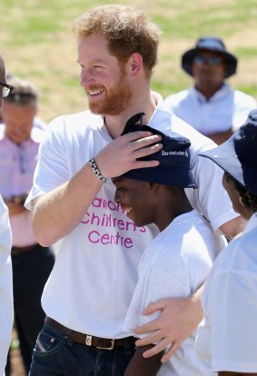 Prince Harry hugs Mutsu Potsane a young boy he made friends with on his first visit to Lesotho.
