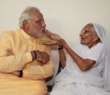 India's prime minister-elect Narendra Modi receives sweets from his mother before leaving for Delhi from her home in Gandhinagar, Gujurat.
