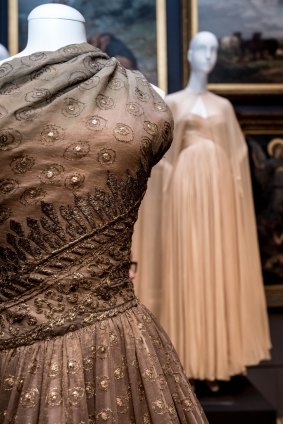 A dress by Christian Dior, left, and one by Gres in the NGV's new collection.