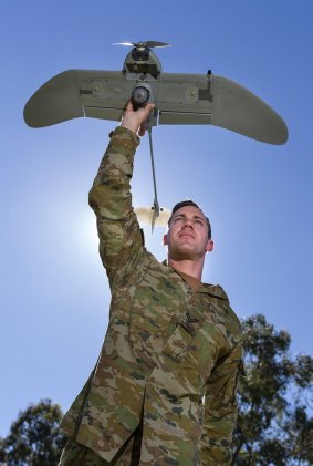 Australian Army soldier Corporal Doug Coombs prepares to launch a Wasp AE drone.