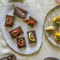 Anchovies and tomato-capsicum relish on rye toast