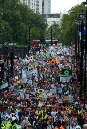 Demonstrators march through Westminster in London, calling on Prime Minister David Cameron to accept more refugees.