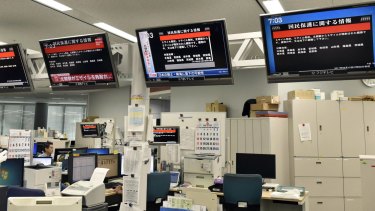TV monitors show the J-Alert (warning siren) at an office of Kyodo News in Tokyo on Friday.