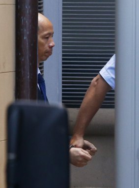 Robert Xie is escorted to a prison truck after being found guilty of the Lin family murders.