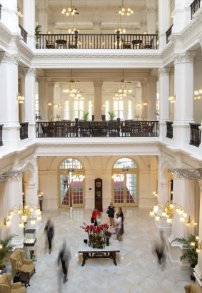 The colonial style lobby from the second floor walkway of the Raffles Hotel. 