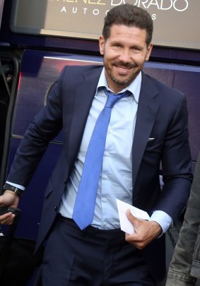All smiles: Atletico Madrid coach Diego Simeone arrives at a Milan hotel.