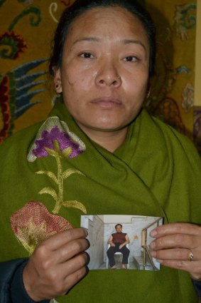 Call for answers: Man Singh Ghale's widow, Sita, holds a photo of her husband.