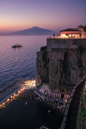 Views across to the twinkling lights of Naples and Vesuvius at night.