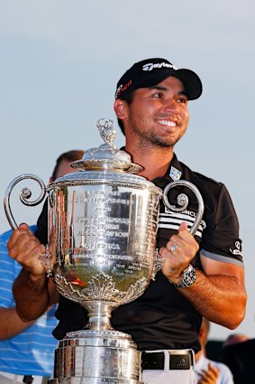 Jason Day celebrates with the Wanamaker trophy.