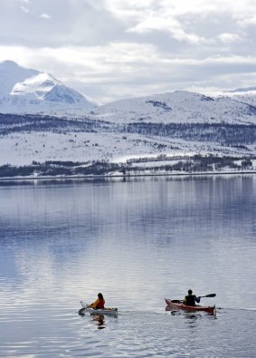  Kayaking on the crystal-clear water in Tromso, Norway.