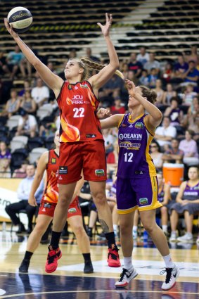 Townsville's Cayla George grabs a rebound ahead of Melbourne's Kate Oliver. 