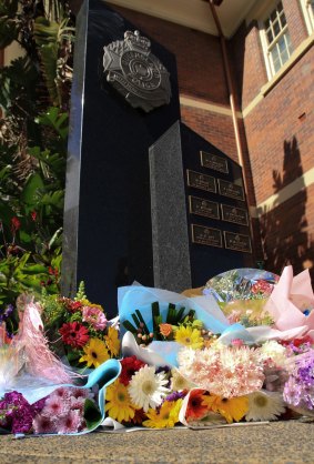 Flowers are left as a memorial for slain officer Brett Forte.