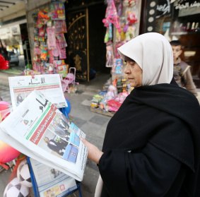 A Palestinian woman reads about the Israeli election result in Gaza. 