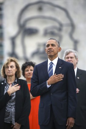 US President Barack Obama listens to the US national anthem in front of a a monument depicting Cuba's revolution hero Ernesto "Che" Guevara during a ceremony at the Jose Marti Monument in Havana on Monday. 