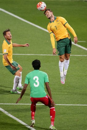 Hang time: Australia's Mathew Leckie heads the ball against Bangladesh.