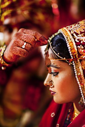 According to custom, the groom puts "sindoor" (holy red colour) on the bride's forehead during a ceremony in Rajasthan.