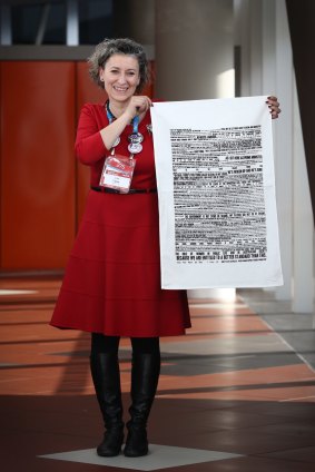 Lisa Carey, Emily's List national co-ordinator, holding one of the tea towels, says the group wants everyone to remember the speech "whatever they're doing".