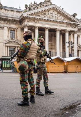 Belgian Army soldiers patrol near shut Christmas stalls in front of the old Brussels' stock exchange on Sunday.