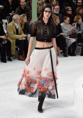 Kendall Jenner flashes her stomach at the Chanel show. 