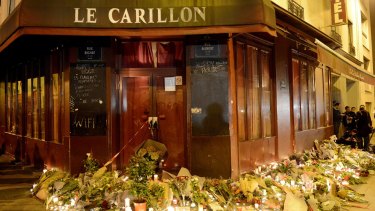 Flowers and candles are placed outside Le Carillon bar.