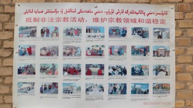 A poster at a mosque in the Xinjiang village of Kuibagh in 2014 shows banned religious practices. A patchwork approach to enforcement has prompted the new law.