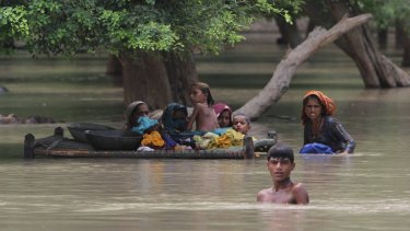 Villagers wade through floodwaters in Rajanpur, Pakistan last month.