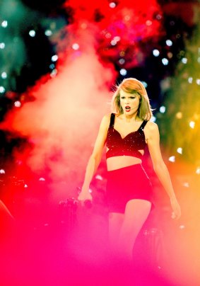 Smoke and mirrors? Taylor Swift, seen here performing at Manchester Arena this week, has joined forces with Apple Music.