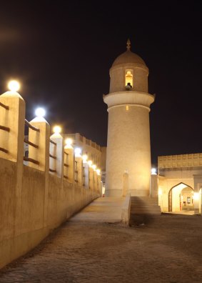 A mosque illuminated at night.