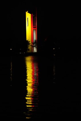 The National Carillon reflecting Belgium's national colours of red, black and yellow on Lake Burley Griffin.