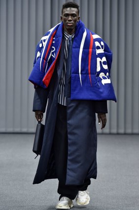  A model walks the runway during the Balenciaga Menswear Fall/Winter 2017-2018 show wearing a throw reminiscent of the Bernie Sanders campaign. 