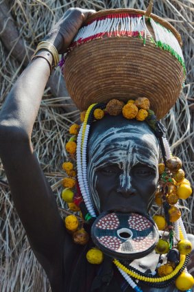 Mursi tribe people with lip plate.