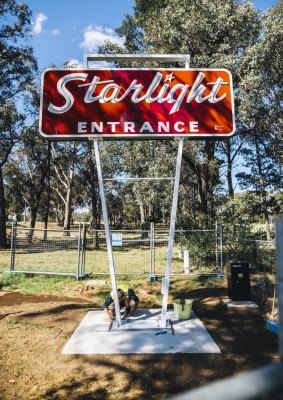 Workers put the final touches on the restored Starlight drive-in sign on Monday.