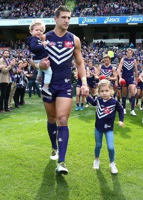 Leading light: Matthew Pavlich leads team onto the field with his children Jack and Harper, before playing final game for the Dockers.