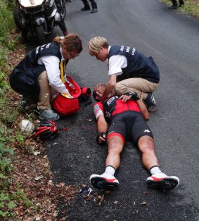 Richie Porte is treated on the ground after the crash. 