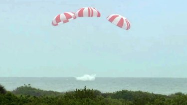 The SpaceX Dragon spaceship drifting down for an ocean landing after the first test of the Dragon's flight abortion sytem off Cape Canaveral, Florida. 